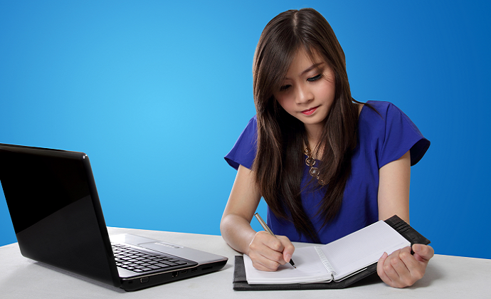 A student working through practice questions at a laptop.